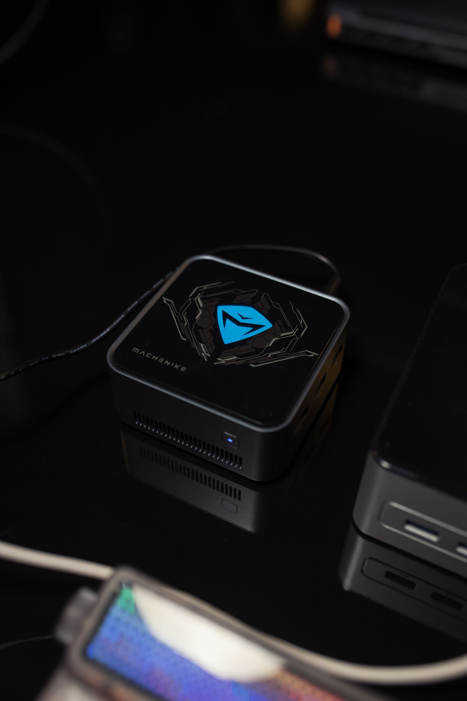 A compact mini PC on a dark desk