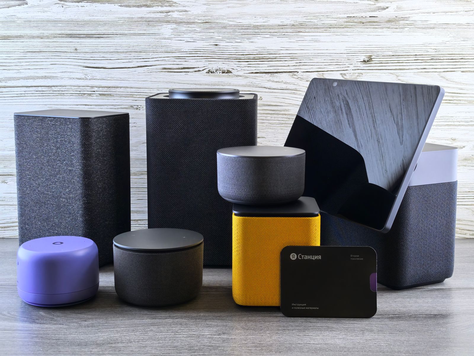 Smart home devices and a tablet on a wooden surface