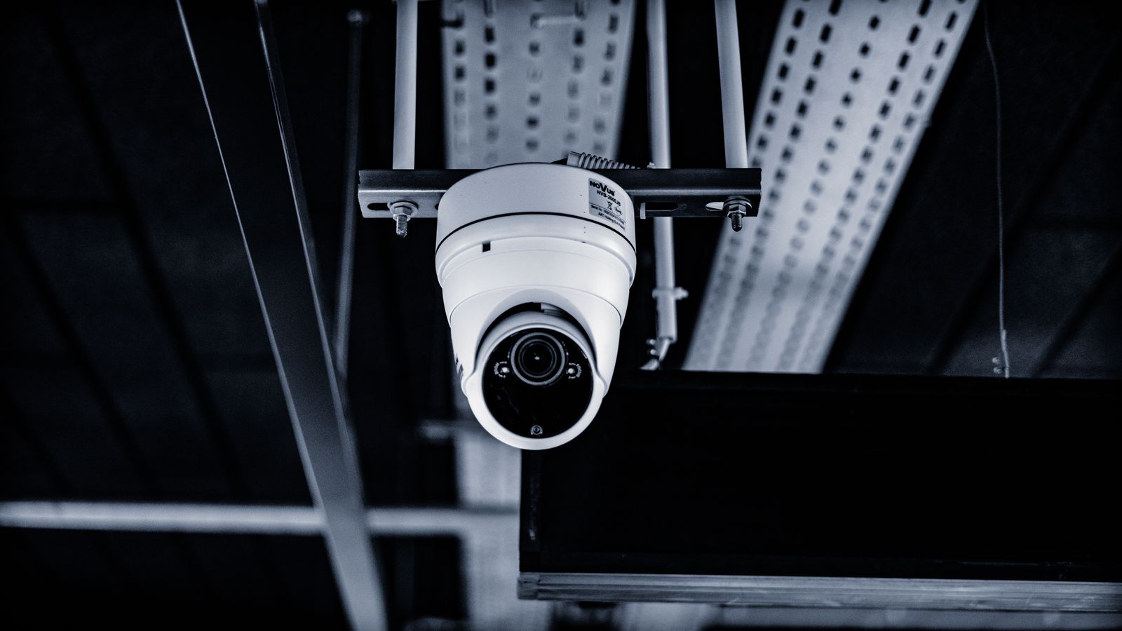 Dome security camera mounted on an industrial ceiling