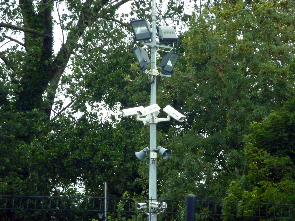 Cluster of outdoor security cameras against a blue sky