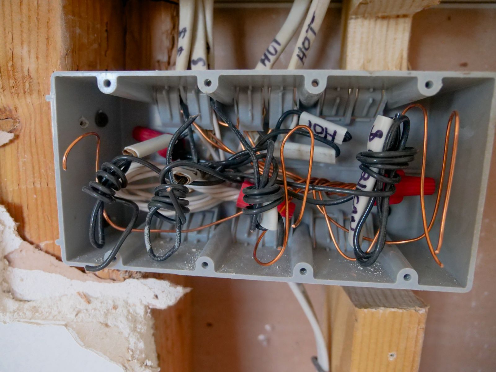 A crowded electrical junction box full of wires and connectors
