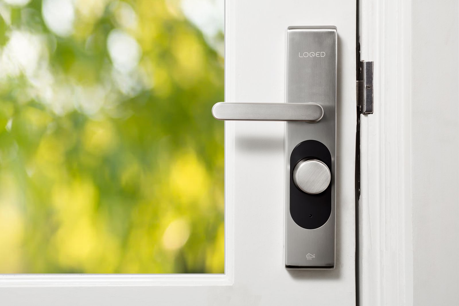 Close-up of a sleek smart door lock on a white door