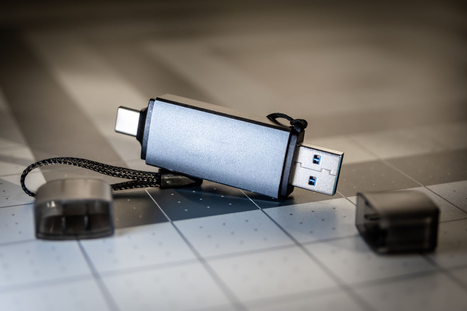 A USB-C and USB-A dongle resting on a desk in low light