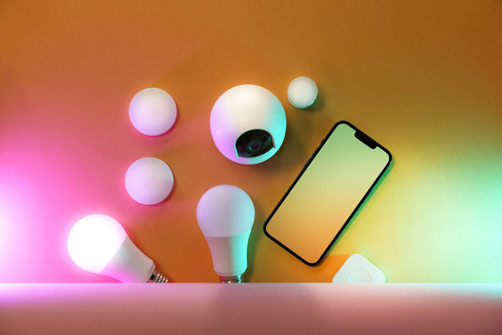 Smart bulbs and a smartphone on a table